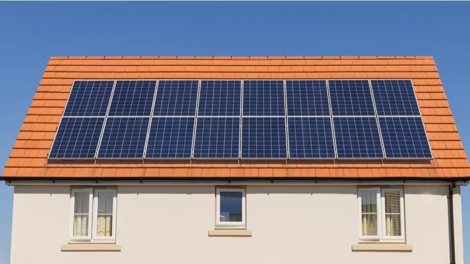 House with solar panels installed on roof showing solar installation